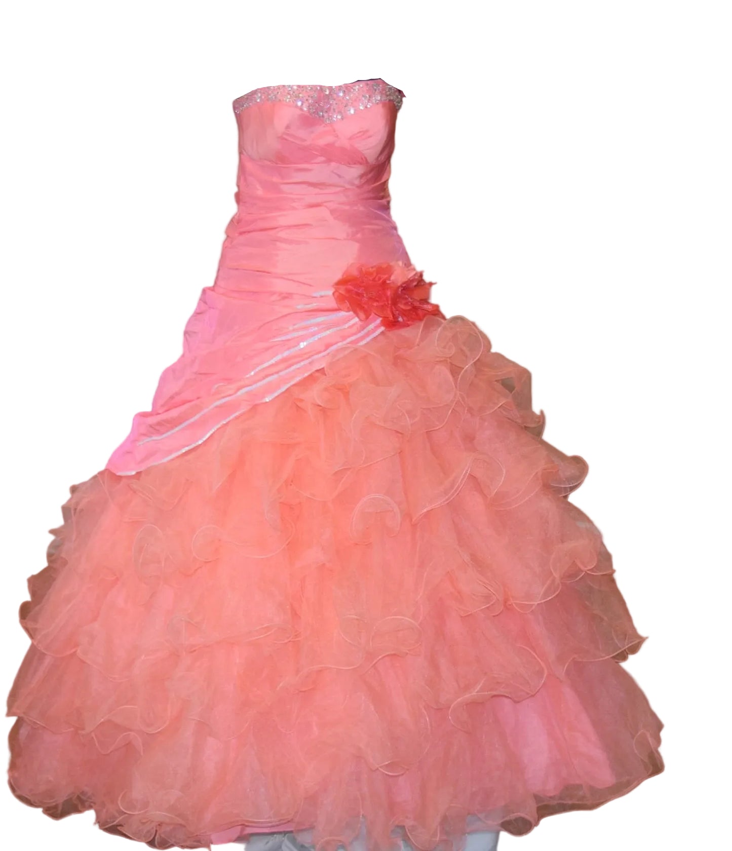 coral ball gown with floral detail on a mannequin against a beige wall.