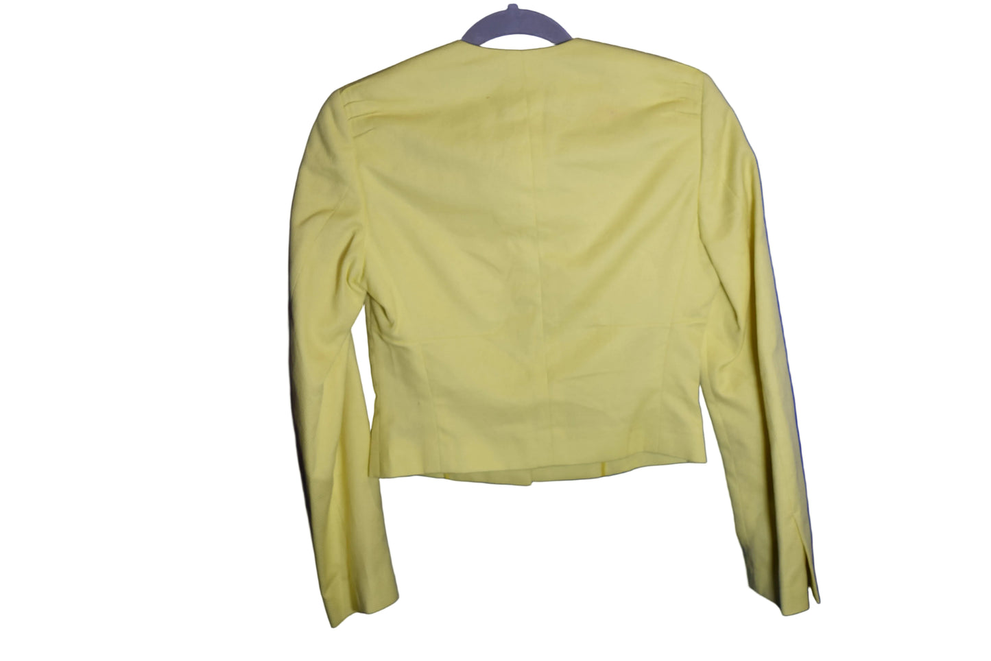 Yellow long-sleeve shirt on a hanger against a blue background