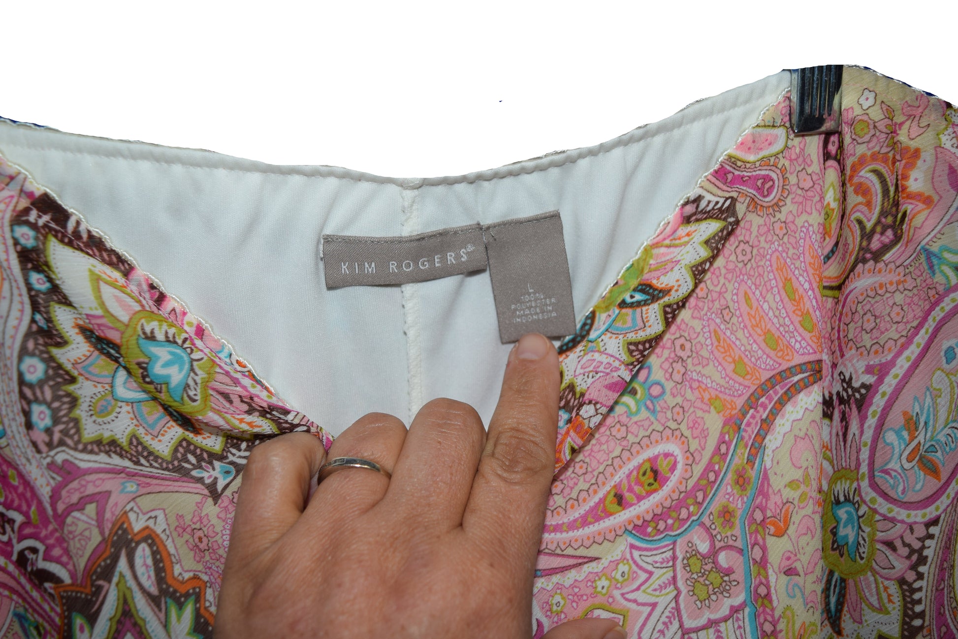 Colorful patterned garment with a Kim Rogers tag on a blue background