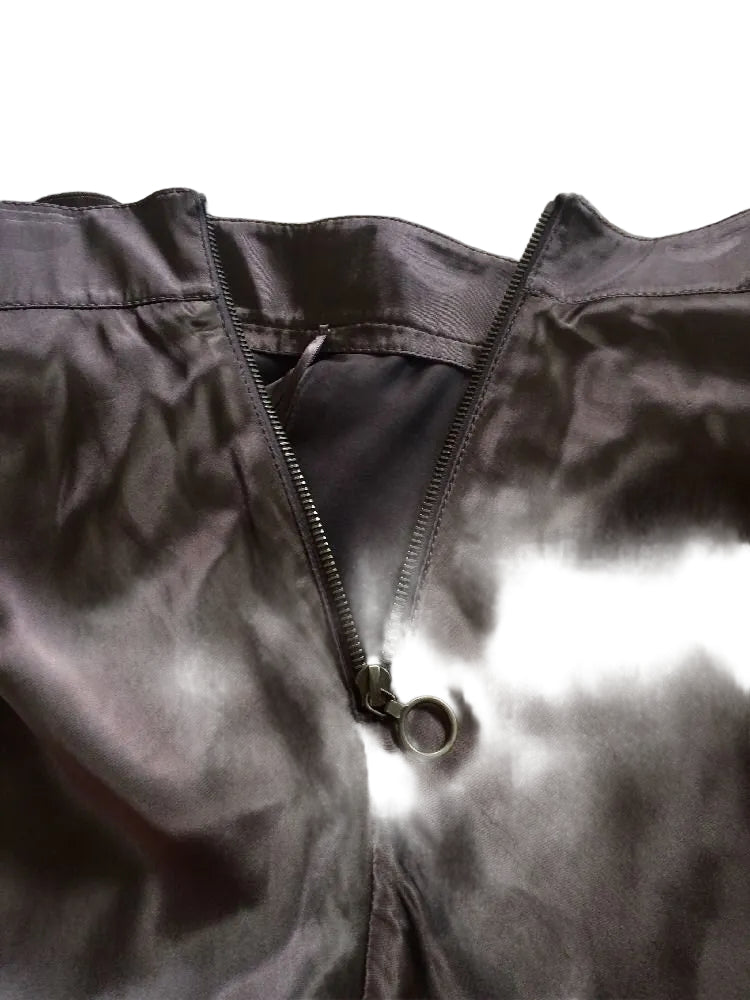Close-up of a brown jacket with a zipper on a textured surface