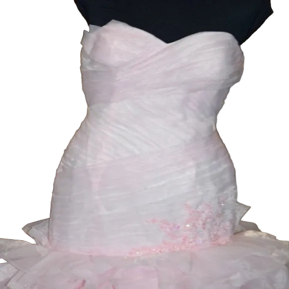 Pink strapless gown with beaded details on a chair.