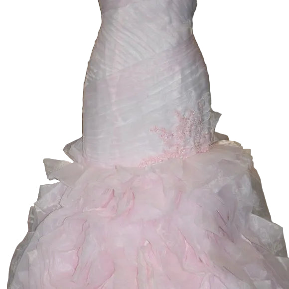 Pink wedding dress with ruffled details on a mannequin.