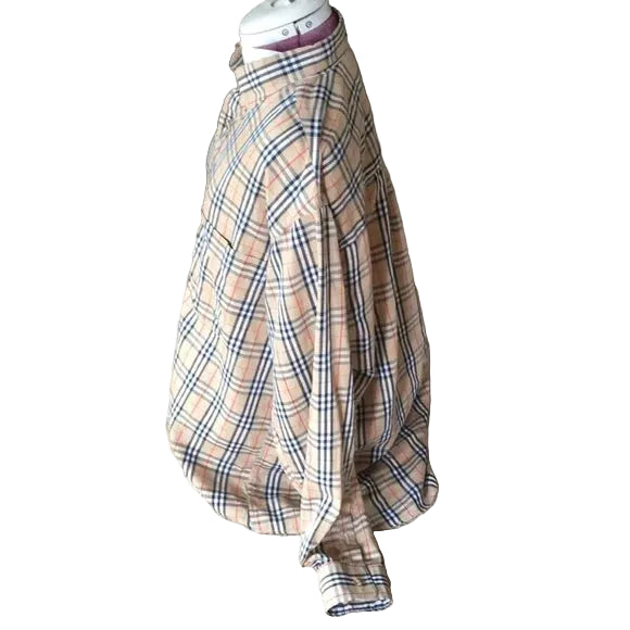 Plaid shirt on a mannequin head with a blurred background