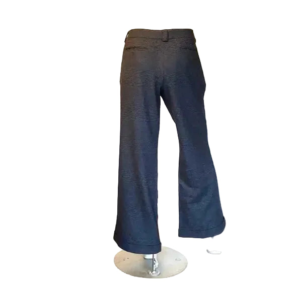 Dark blue pants on a mannequin in a room with a HP Pavilion computer in the background.