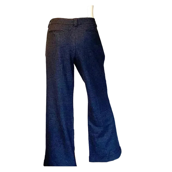 Blue bell-bottom pants on a mannequin against a white background